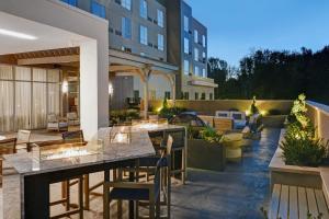 an outdoor patio of a hotel with tables and chairs at Courtyard by Marriott Hamilton in Hamilton