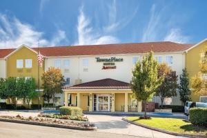 a front view of a hotel with an american flag at TownePlace Suites by Marriott San Antonio Northwest in San Antonio