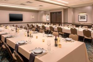 a conference room with tables and chairs and a flat screen tv at Courtyard by Marriott Denver Downtown in Denver