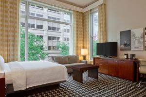 a bedroom with a bed and a flat screen tv at Courtyard by Marriott Denver Downtown in Denver