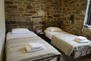 A bed or beds in a room at by karakas Λίθινο