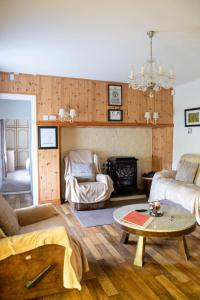 a living room with a couch and a table at Sheila's Cottage Ballyheigue in Ballyheigue