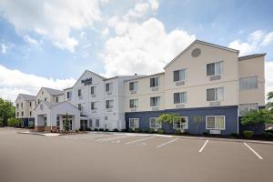 a large white building with a parking lot at Fairfield Inn & Suites Indianapolis Airport in Indianapolis