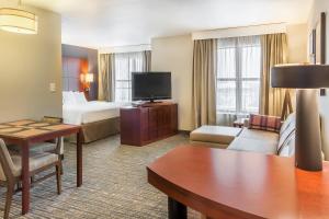 a hotel room with a bed and a living room at Residence Inn Lexington Keeneland/Airport in Lexington