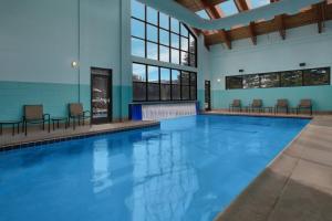 a large swimming pool with chairs in a building at Marriott's StreamSide Evergreen at Vail in Vail