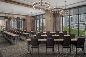 a dining room with tables and chairs and large windows at AC Hotel By Marriott Miami Brickell in Miami