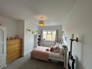 a bedroom with a bed and a guitar in it at West Kirby home for Open golf at Hoylake in West Kirby