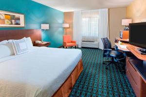 a hotel room with a large bed and a desk at Fairfield Inn Tuscaloosa in Tuscaloosa