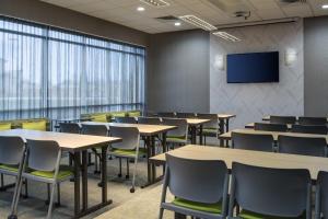 a conference room with tables and chairs and a tv at SpringHill Suites by Marriott Oklahoma City Midwest City Del City in Del City