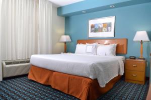 a bedroom with a large bed with blue walls at Fairfield Inn & Suites Effingham in Effingham