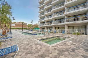 a large apartment building with two pools in a courtyard at Forest Dunes Penthouse 1801 in Myrtle Beach