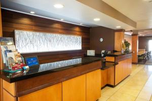 a lobby of a hotel with a reception counter at Fairfield Inn and Suites by Marriott Muskogee in Muskogee