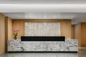 a lobby with a marble counter and a window at AC Hotel by Marriott Bethesda Downtown in Bethesda