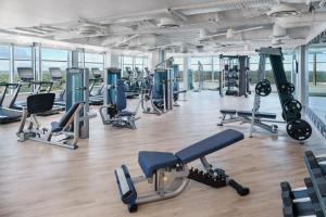 a gym with lots of treadmills and machines at AC Hotel by Marriott Bethesda Downtown in Bethesda