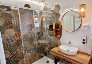 a bathroom with a shower and a sink and a mirror at Hotel SAMARIN Črnomelj in Črnomelj +135 photos