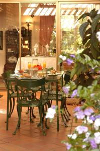 a table and chairs with food and drinks on it at Elonda B&B in Pretoria