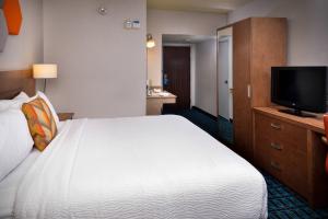 a hotel room with a bed and a flat screen tv at Fairfield Inn Las Vegas Convention Center in Las Vegas