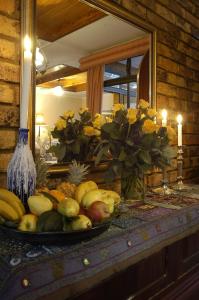 a plate of fruit on a table in front of a mirror at Elonda B&B in Pretoria