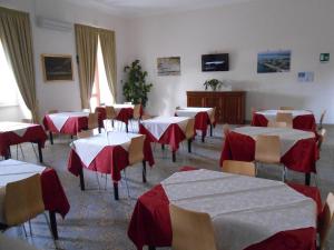 a dining room with red and white tables and chairs at Sacro Cuore Opera Don Guanella in Torre Canne