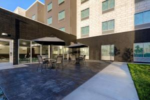 a patio with chairs and umbrellas in front of a building at Fairfield by Marriott Inn & Suites St. Paul Eagan in Eagan