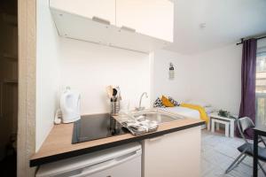 a kitchen with a sink and a counter top at Appartement tout équipé à juste coté du tramway in Marseille