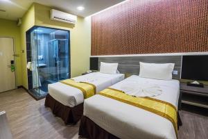 Postel nebo postele na pokoji v ubytování Indra Hotel Ipoh