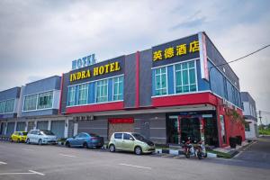 a large building with cars parked in front of it at Indra Hotel Ipoh in Ipoh