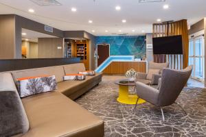 a lobby with a couch and chairs and a slide at SpringHill Suites Orlando Altamonte Springs/Maitland in Orlando