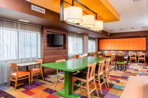 a conference room with a green table and chairs at Fairfield Inn & Suites Lincoln in Lincoln