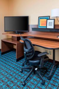 an office with a desk with a monitor and a chair at Fairfield Inn & Suites Lincoln in Lincoln