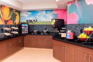 a kitchen with a counter with food on it at Fairfield Inn & Suites Lincoln in Lincoln