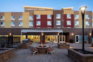 a courtyard with chairs and a fountain in front of a building at TownePlace Suites by Marriott Twin Falls in Twin Falls