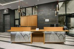 a reception desk in a lobby with two desks at TownePlace Suites by Marriott New York Manhattan/Chelsea in New York