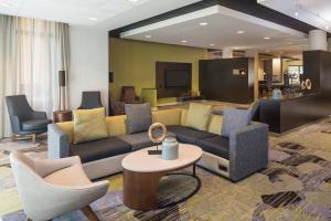 a living room with couches and a table and chairs at Courtyard by Marriott Miami West/FL Turnpike in Miami