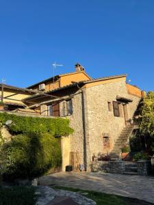 a large stone building with a staircase in front of it at Atelier Fuori Città in Perugia