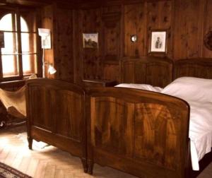 a bedroom with wood paneled walls and two beds at Ferienwohnung - a85554 in Promontogno