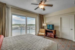 a bedroom with a bed and a balcony with a television at Huge Luxury 2/2 AAA Four Diamond Resort by Luxury Beach Rentals in Myrtle Beach