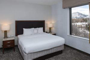 a hotel room with a bed and a large window at SpringHill Suites by Marriott Logan in Logan