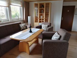 a living room with two couches and a wooden table at Flat in Polle near the forest in Polle