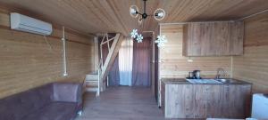 a kitchen with a couch and a sink in a room at Time House in Kokotauri