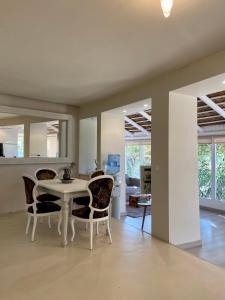 a dining room with a white table and chairs at Finca El Cañuelo in Bolonia