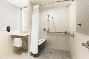 a bathroom with a shower and a sink at Courtyard New York Downtown Manhattan/Financial District in New York
