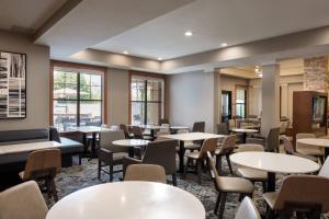 a dining room with tables and chairs and windows at Residence Inn by Marriott Camarillo in Camarillo