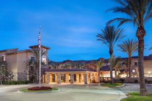 a large building with palm trees in front of it at Residence Inn by Marriott Camarillo in Camarillo