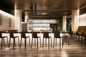 a bar in a hotel with chairs and tables at AC Hotel Tucson Downtown in Tucson