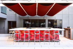 a red and white bar in a building with stools at AC Hotel Tucson Downtown in Tucson