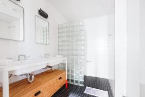 a bathroom with a sink and a shower at Placemakr Wall Street in New York