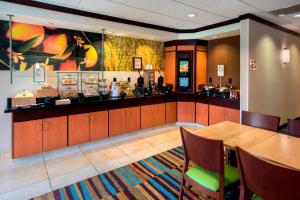 a restaurant with a table and a food counter at Fairfield Inn & Suites Verona in Verona