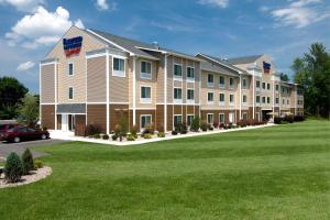 a large apartment building with a green lawn at Fairfield Inn & Suites Verona in Verona