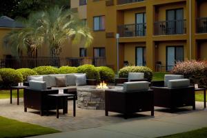 a courtyard with furniture and a fire pit in front of a building at Courtyard by Marriott Macon in Macon